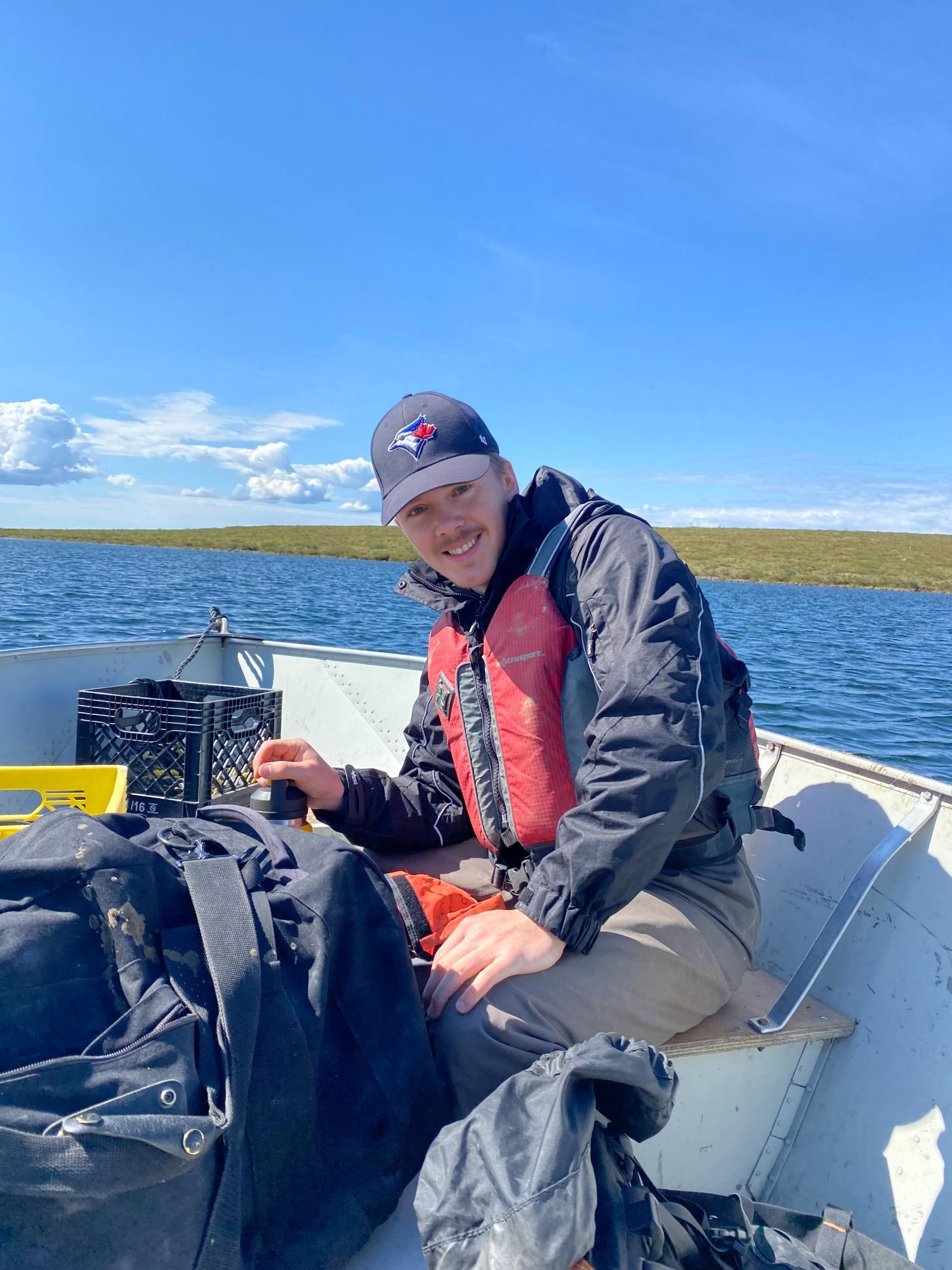 Landon Murphy taking baseline water quality data at Connor Lake, in support of Burgundy’s Point Lake Project.